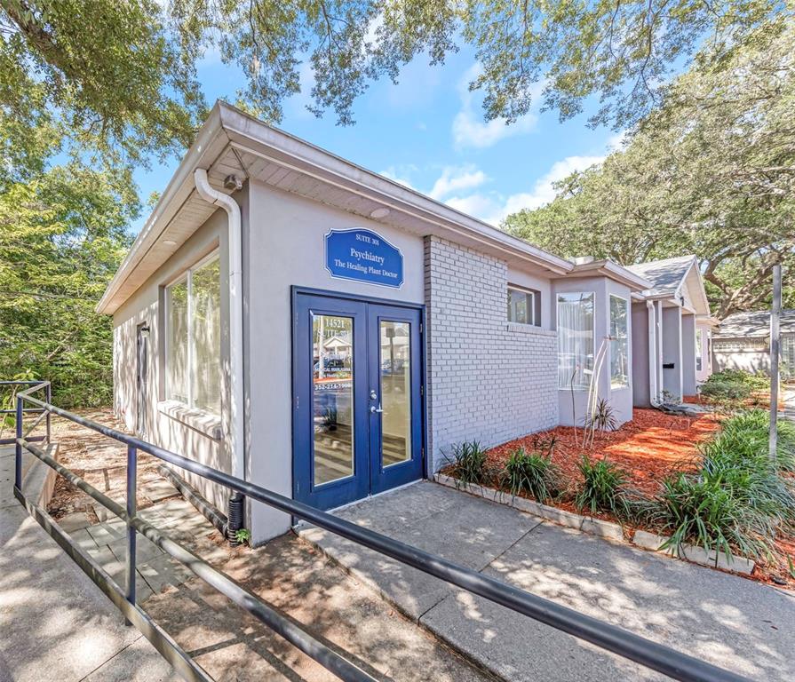 The exterior of a single-story medical office building features a blue double-door entrance and ramp — 14517 BRUCE B DOWNS BOULEVARD UNIT 301, TAMPA, FL