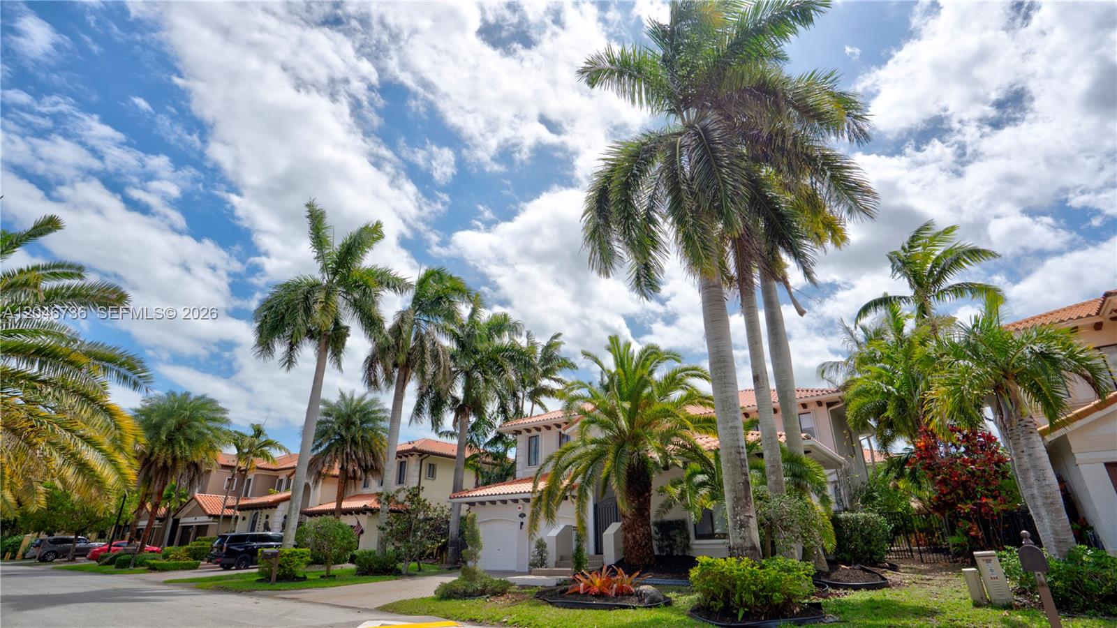 A two-story house with a tile roof is surrounded by numerous tall palm trees — 7956 SW 195th St, Cutler Bay FL 33157, CUTLER BAY, FL
