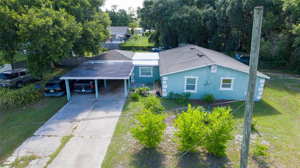 An aerial view of a teal, single-story house with a carport and a concrete driveway — 19 S TYLER AVENUE, ORLANDO, FL