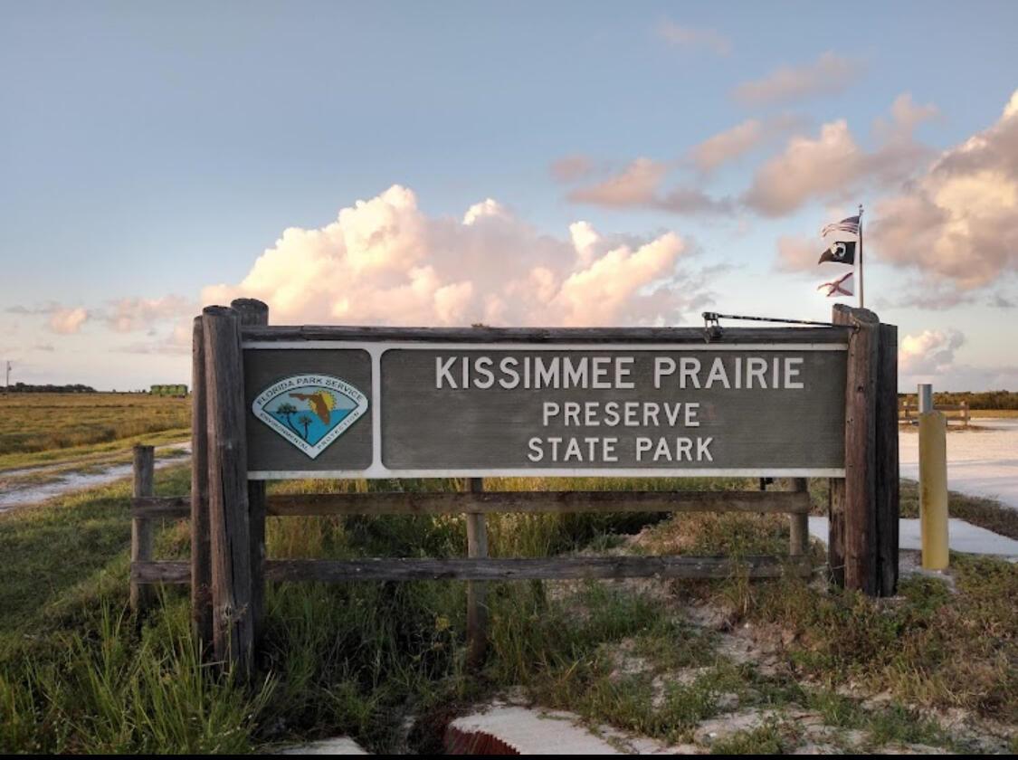 A wooden sign marks the entrance to Kissimmee Prairie Preserve State Park under a cloudy sky — 0 NW 302, Okeechobee FL 34972, OKEECHOBEE, FL