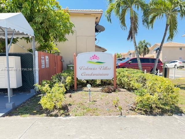 A sign for Valencia Villas Condominium stands in front of a building and palm trees — 3260 W 70th St # 202, Hialeah FL 33018, HIALEAH, FL