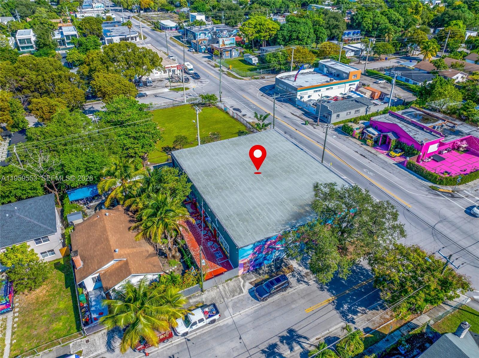 An aerial view shows a flat-roofed commercial building with mural-covered walls and surrounding neighborhood streets — 4000 NW 2nd Ave, Miami FL 33127, MIAMI, FL