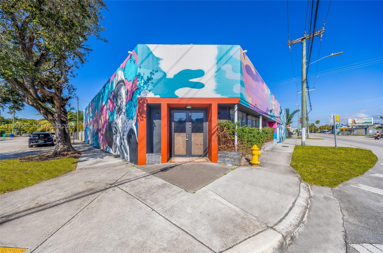 A corner building features a colorful mural, an orange-framed entrance, and a yellow fire hydrant — 4000 NW 2nd Ave, Miami FL 33127, MIAMI, FL
