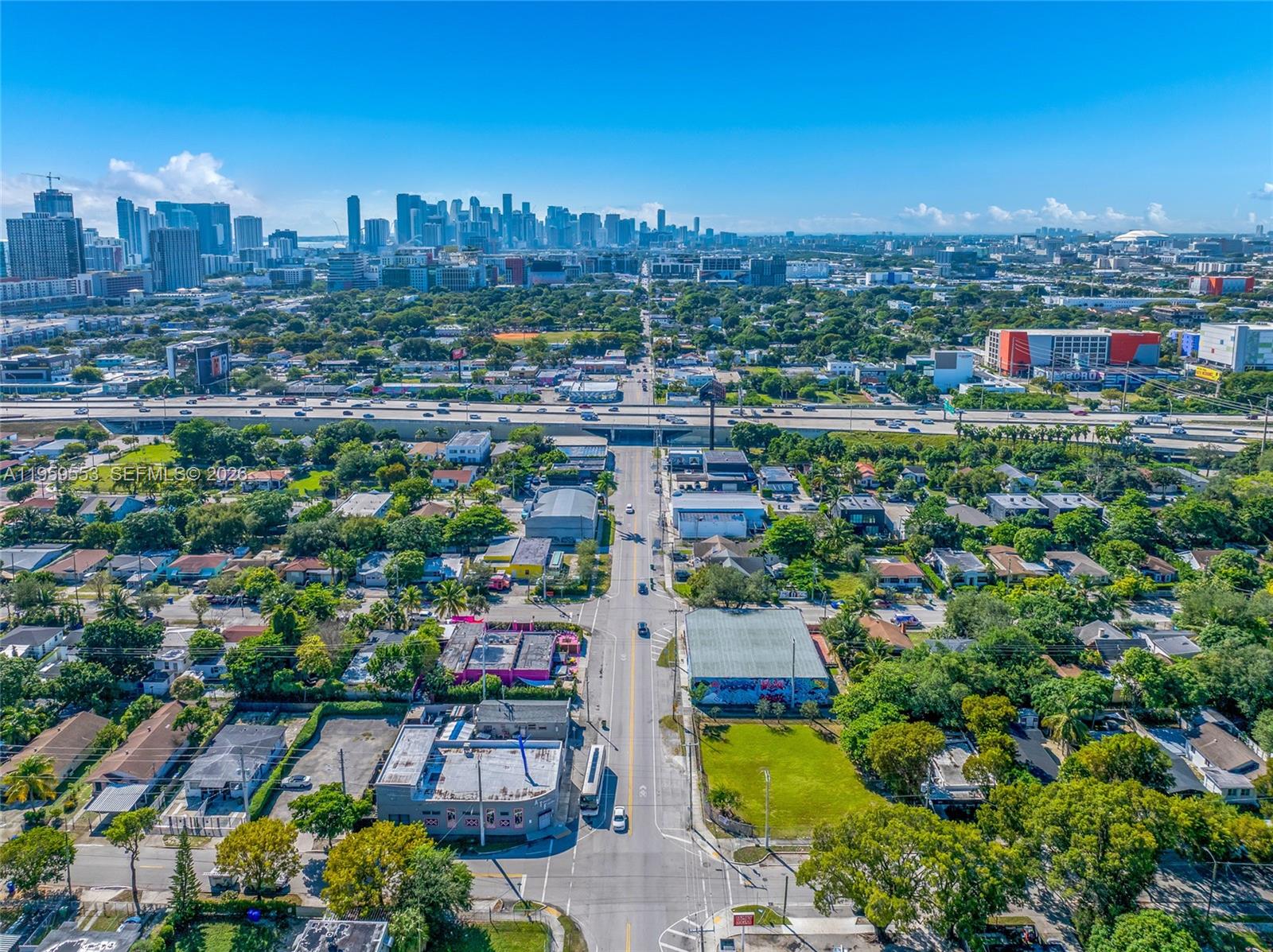 An aerial view shows a city street leading toward a distant skyline and highway — 4000 NW 2nd Ave, Miami FL 33127, MIAMI, FL