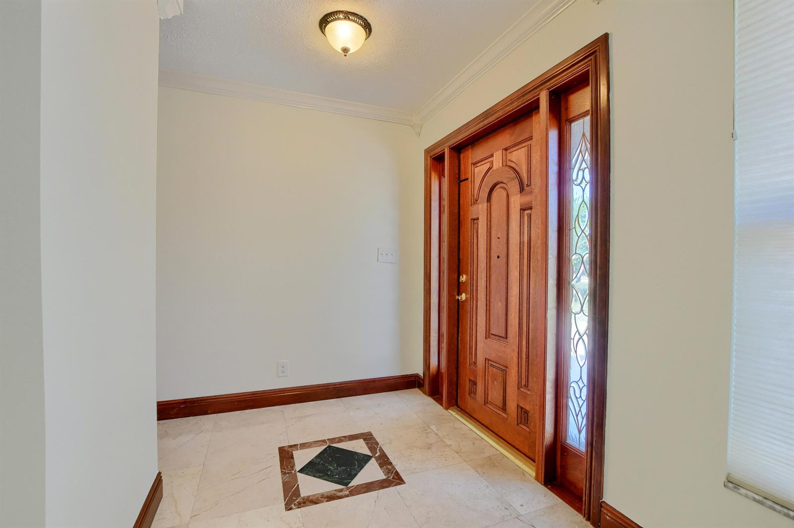 An entryway features a wooden front door with a sidelight, tile flooring, and a ceiling light — 2334 Timbercreek Circle NW, Boca Raton FL 33431, BOCA RATON, FL