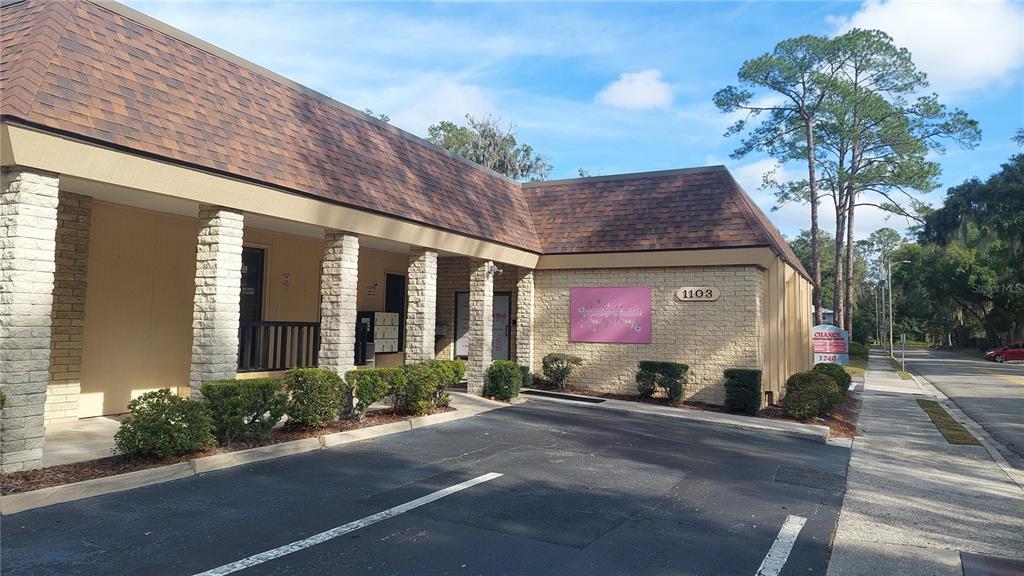 A single-story commercial building with a brick facade and a brown shingled roof — 1103 NW 13TH STREET, GAINESVILLE, FL