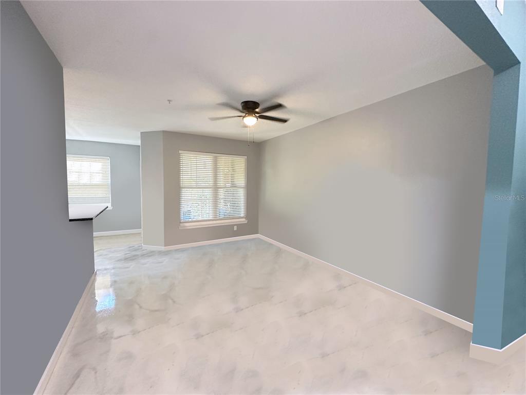 A covered outdoor walkway features brick columns, arched windows, and a red-painted concrete floor — 1810 E PALM AVENUE UNIT 1113, TAMPA, FL