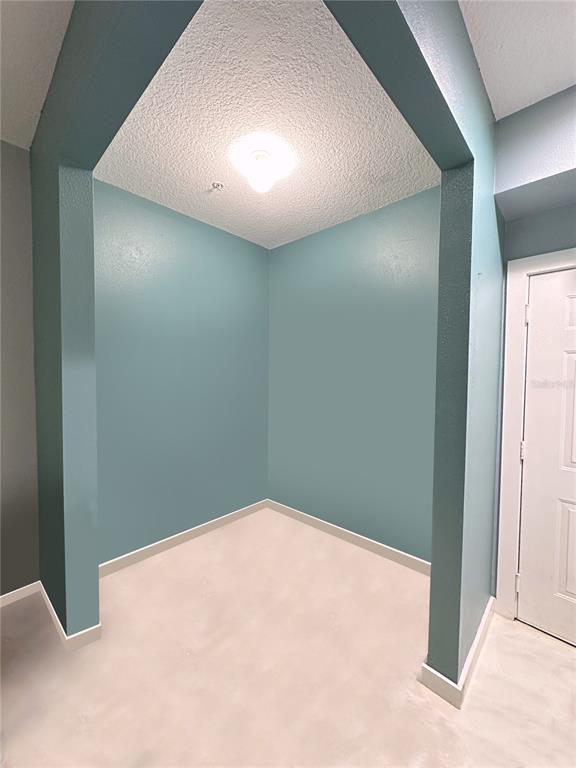 An empty room features light blue walls, a ceiling fan, and polished marble-look flooring — 1810 E PALM AVENUE UNIT 1113, TAMPA, FL