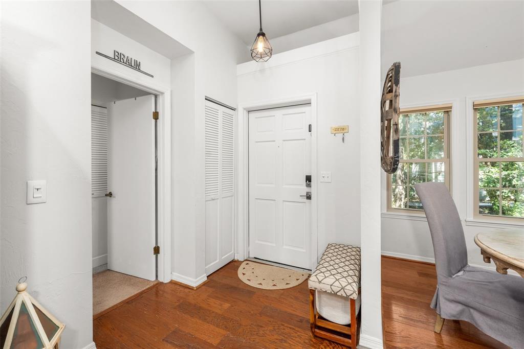 An entryway features a white front door, hardwood floors, a small bench, and a closet — 5225 SW 86TH TERRACE, GAINESVILLE, FL