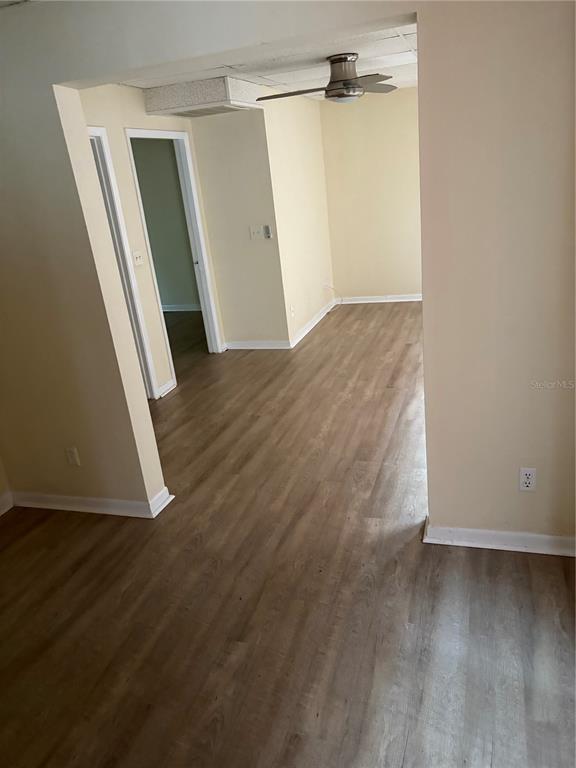 An interior view showing a living area with light wood-look flooring and a ceiling fan — 111 S NEWPORT AVENUE UNIT 6, TAMPA, FL