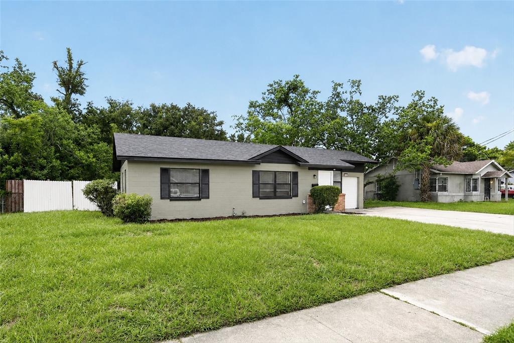 A single-story house with a gray brick exterior, dark shutters, and a shingled roof — 3402 LEWIS COURT, ORLANDO, FL