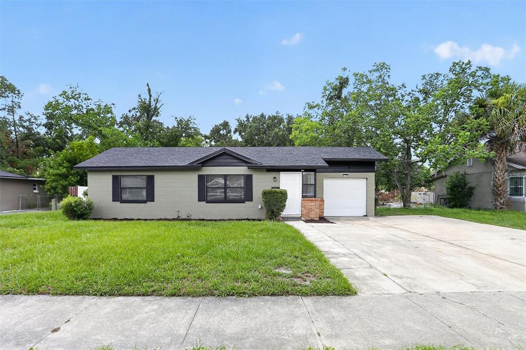 A single-story house with a gray exterior, black shutters, and an attached one-car garage — 3402 LEWIS COURT, ORLANDO, FL