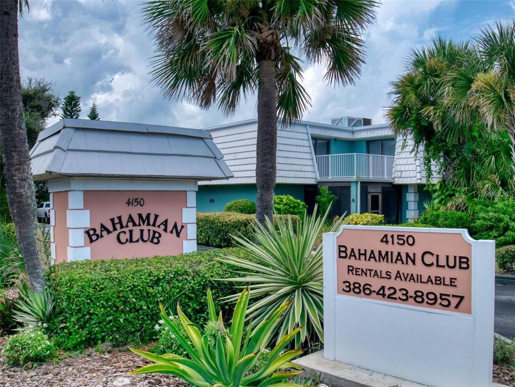 A sign for the Bahamian Club stands in front of a multi-story apartment building — 4150 S ATLANTIC AVENUE UNIT 113D, NEW SMYRNA BEACH, FL