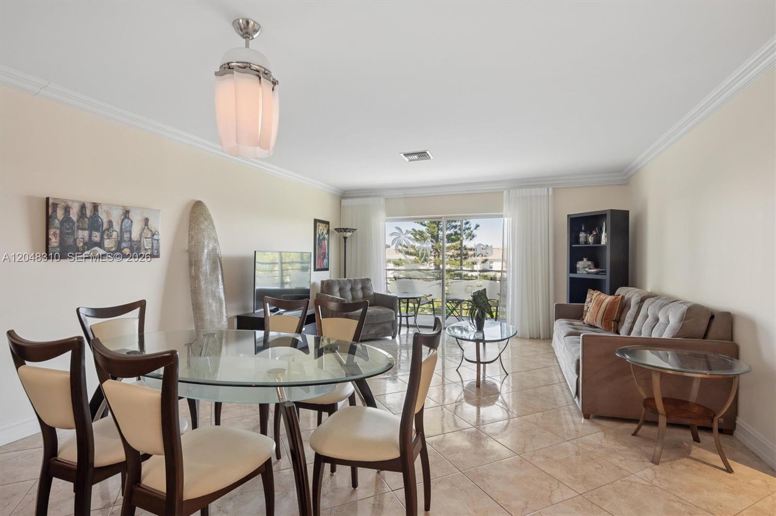 A living and dining area features tile floors, a glass table, and a balcony view — 1000 Hillcrest Ct # 303, Hollywood FL 33021, HOLLYWOOD, FL