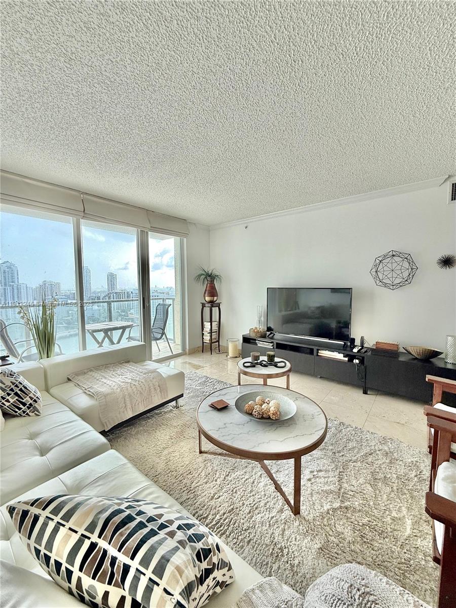 A living room features a white sectional sofa, two round coffee tables, and floor-to-ceiling windows — 1155 BRICKELL BAY DR # 2708, Miami FL 33131, MIAMI, FL