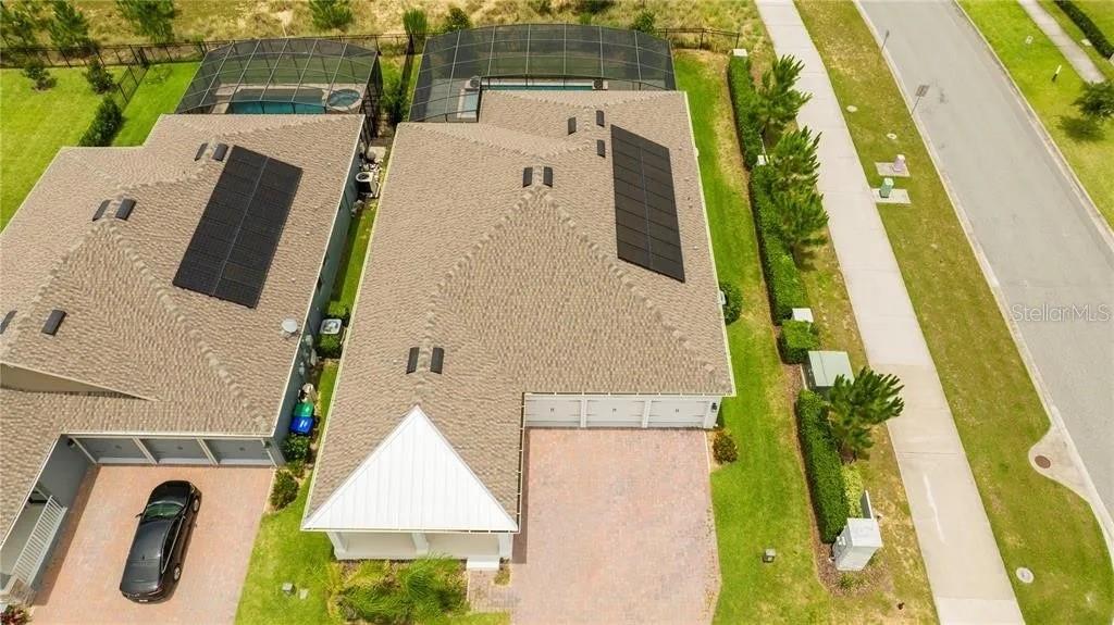 An aerial view shows two suburban houses with swimming pools and solar panels on their roofs — 14711 WINTER STAY DRIVE, WINTER GARDEN, FL