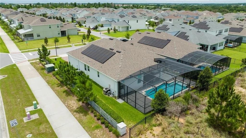 An aerial view of a suburban house with a screened-in pool and solar panels — 14711 WINTER STAY DRIVE, WINTER GARDEN, FL