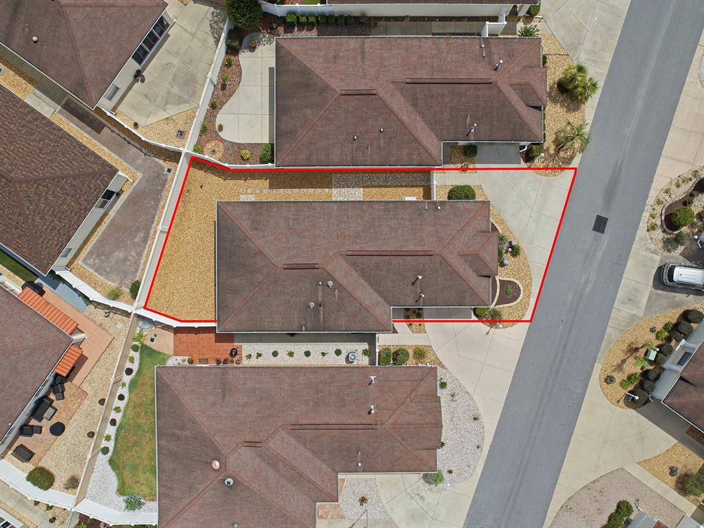 An aerial view shows a residential house with a red outline highlighting its property boundaries — 7631 SE 170TH LONGVIEW LANE, THE VILLAGES, FL