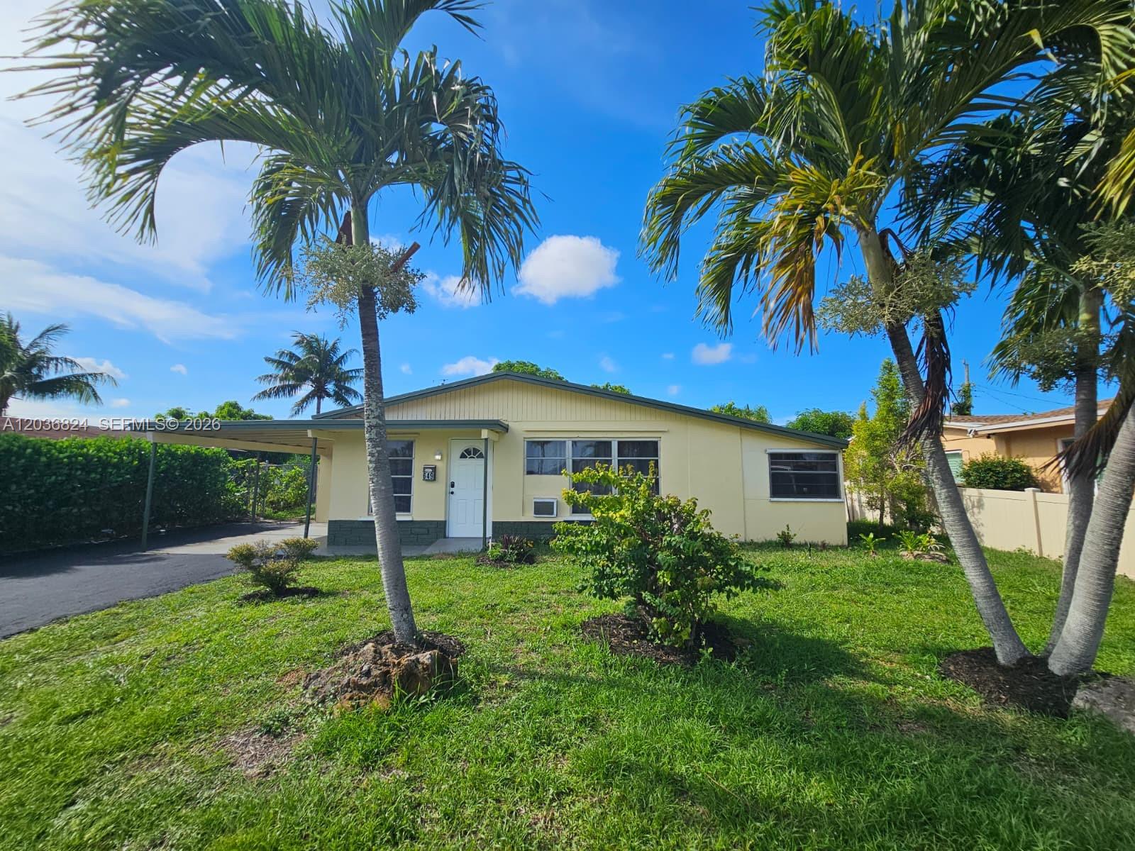 A single-story yellow house with a carport and palm trees in the front yard — 649 NW 19th St, Pompano Beach FL 33060, POMPANO BEACH, FL