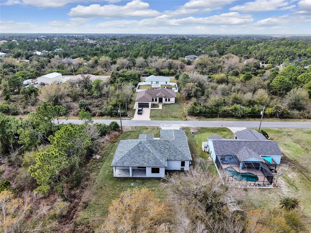 An aerial view shows two houses in the foreground and one across the street — 6192 KAMBACH STREET, PORT CHARLOTTE, FL
