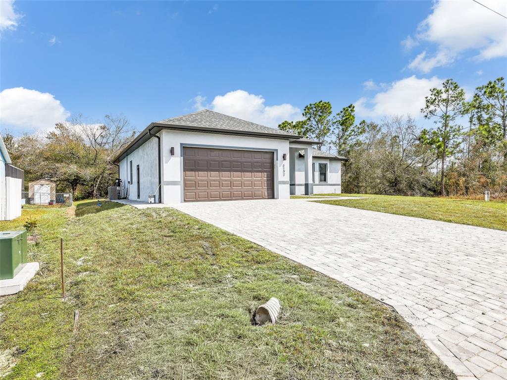 A single-story house with a brown garage door and a paved driveway sits on grass — 6192 KAMBACH STREET, PORT CHARLOTTE, FL