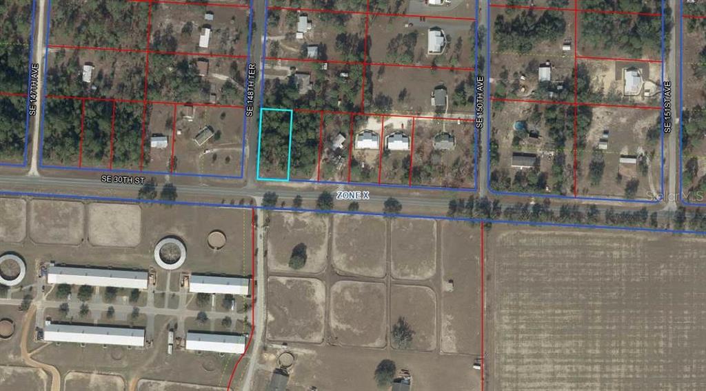 This aerial map shows a vacant rectangular lot outlined in blue along a paved road — TBD SE 30TH STREET, MORRISTON, FL