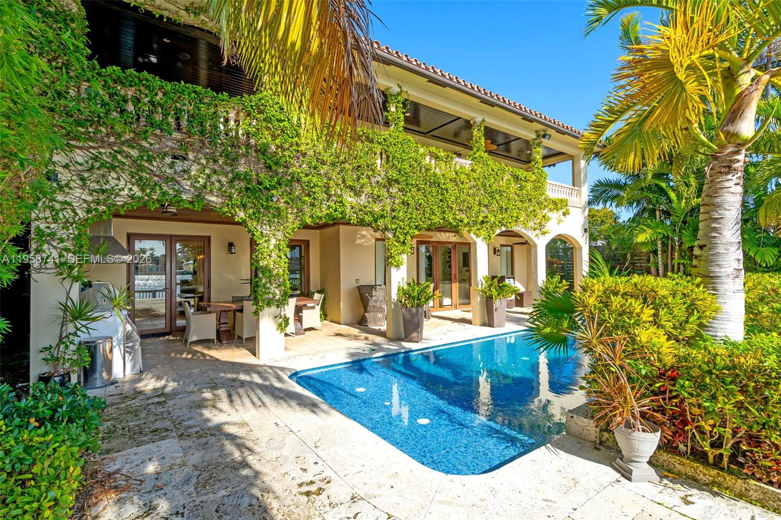 A two-story house with a swimming pool, covered patio, and lush landscaping — 1398 Bay Dr, Miami Beach FL 33141, MIAMI BEACH, FL