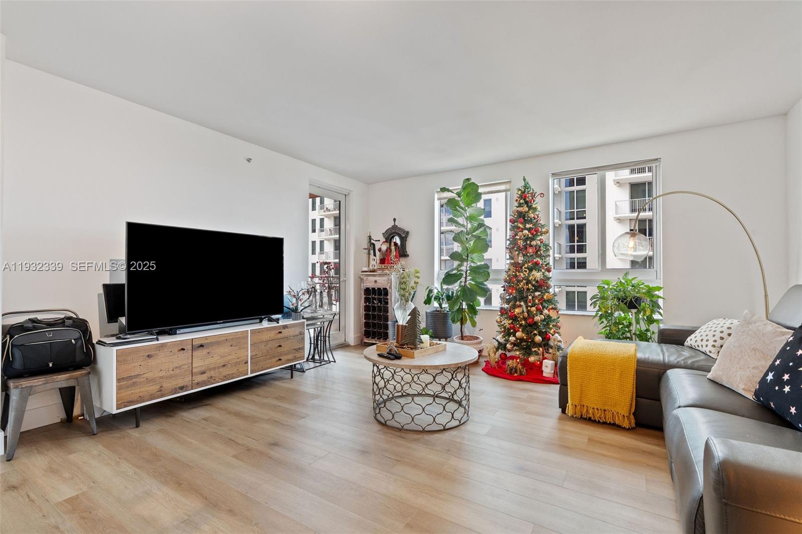 A living room features a large television, a Christmas tree, and a gray sectional sofa — 7350 SW 89th St # 1110S, Miami FL 33156, MIAMI, FL