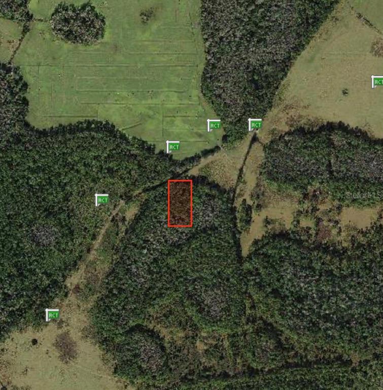 An aerial map view shows a rectangular plot of land outlined in red — POLK CITY, POLK CITY, FL