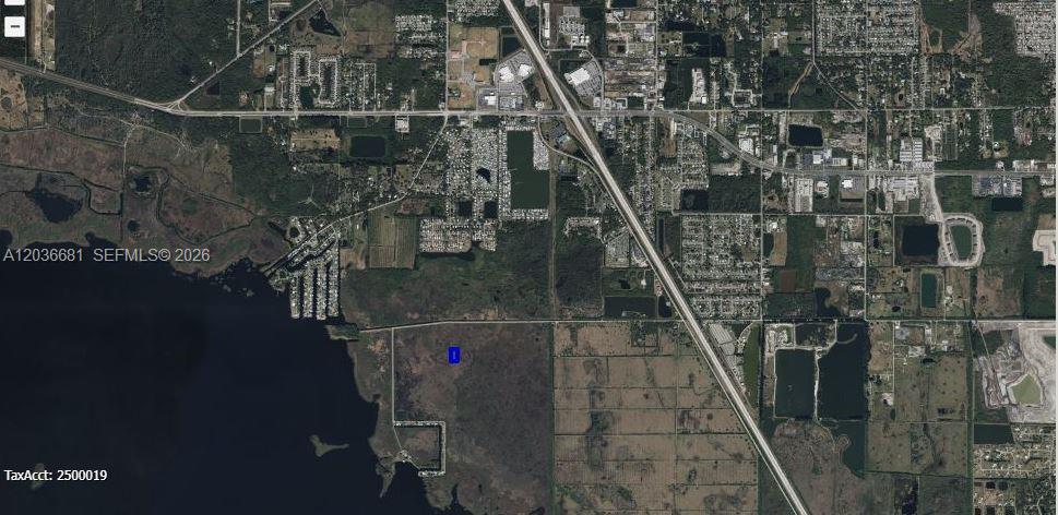 This is an aerial map showing a vacant plot of land near a large lake — 0 UNKNOWN, Cocoa FL 32926, COCOA, FL