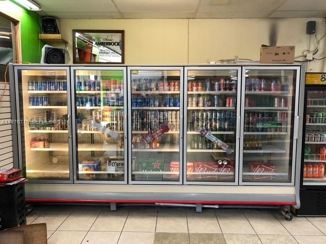 A large commercial glass-door refrigerator displays various beverages inside a retail store — 5600 NE 2nd Ave # A, Miami FL 33137, MIAMI, FL
