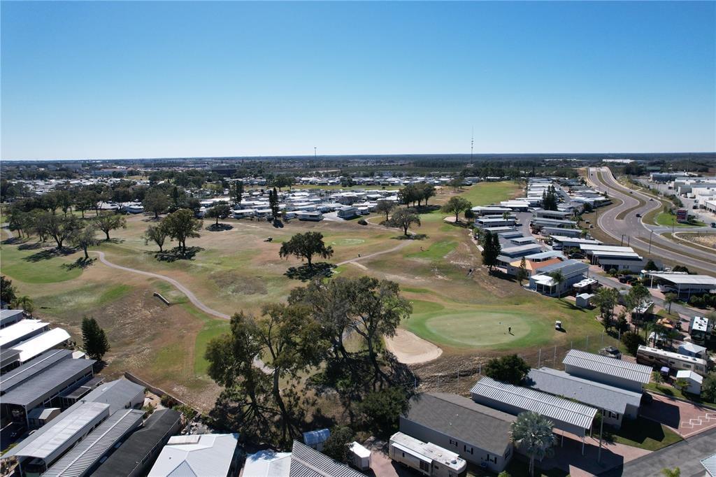 An aerial view shows a golf course surrounded by a mobile home community — 2253 ST GEORGE DRIVE, DAVENPORT, FL
