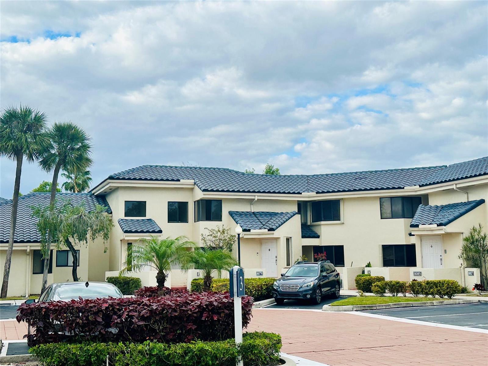 A two-story residential building with a dark tiled roof and beige stucco exterior — 8142 NW 17th Manor, Plantation FL 33322, PLANTATION, FL