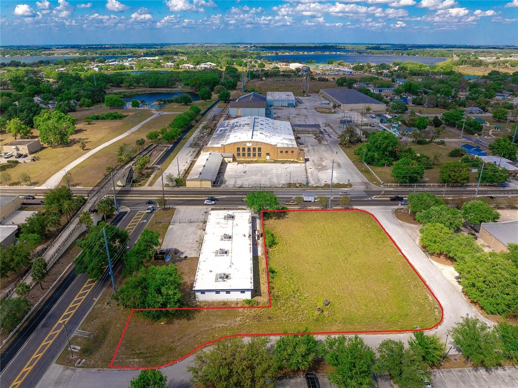 An aerial view shows a vacant lot and a rectangular building outlined in red — 0 OLYMPIAN WAY, WINTER HAVEN, FL