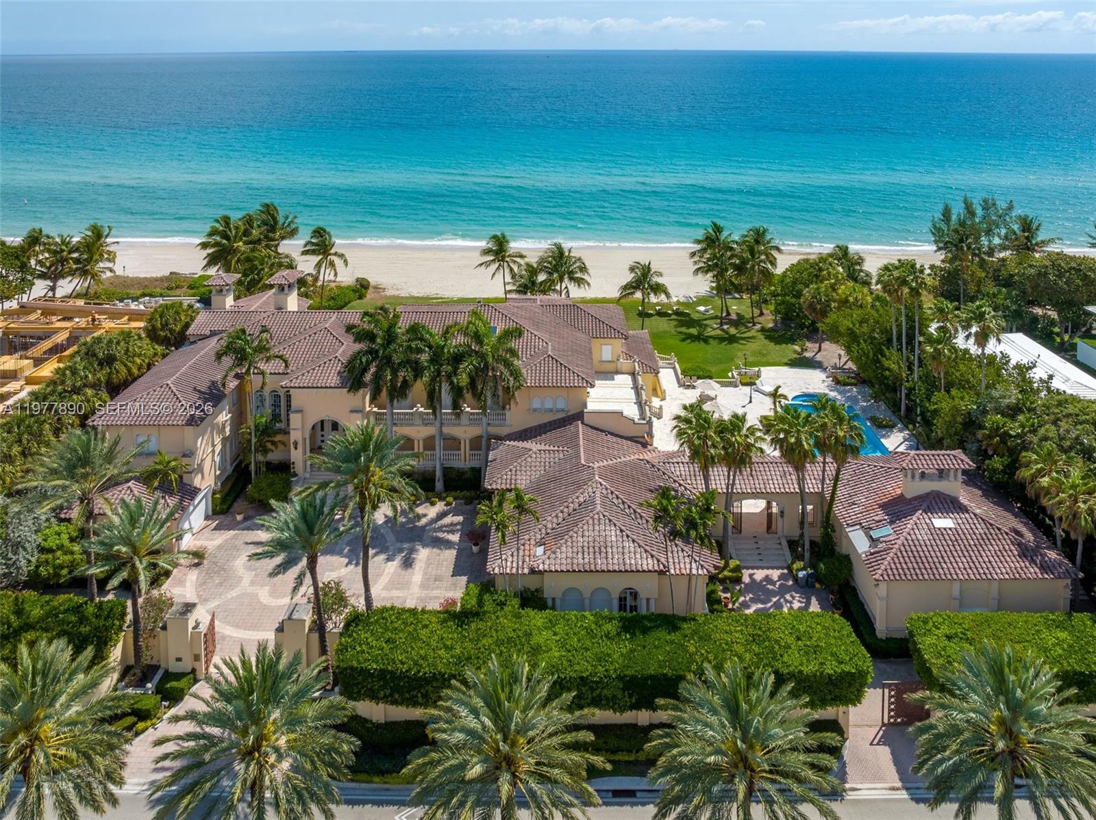 An aerial view of a large Mediterranean-style beachfront estate with a pool and palm trees — 355 Ocean Blvd, Golden Beach FL 33160, GOLDEN BEACH, FL