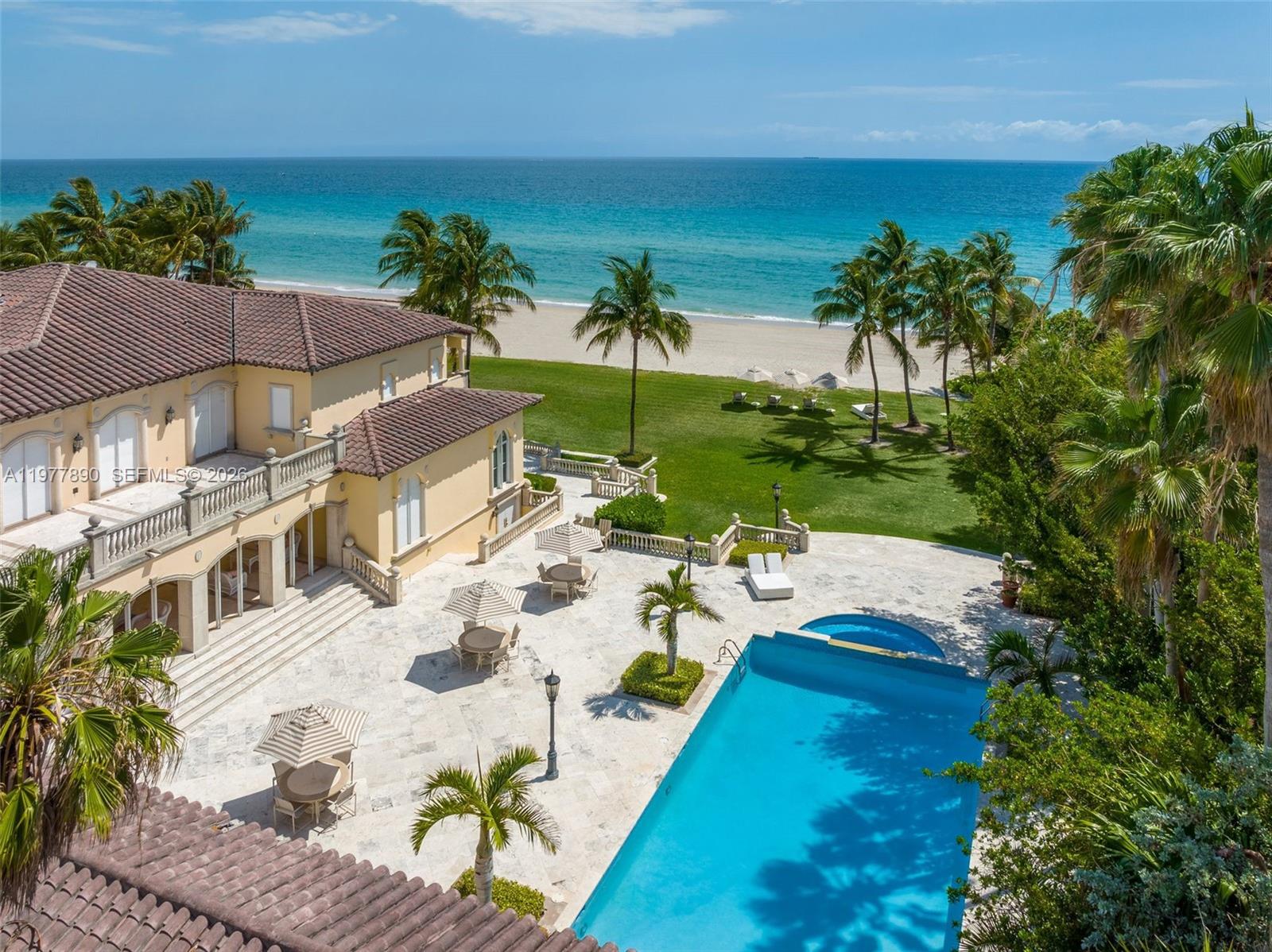An aerial view of a coastal mansion featuring a swimming pool, patio, and beach access — 355 Ocean Blvd, Golden Beach FL 33160, GOLDEN BEACH, FL