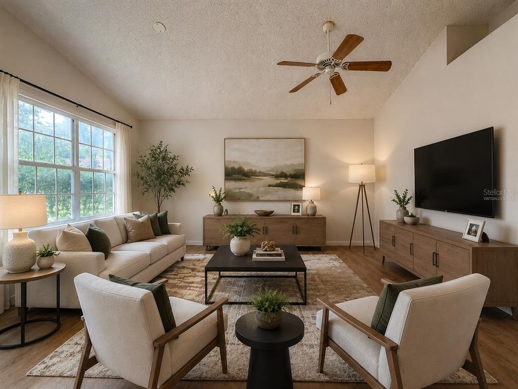 A living room features a sofa, two armchairs, a coffee table, and a wall-mounted television — 6608 NORTHHAVEN COURT, RIVERVIEW, FL