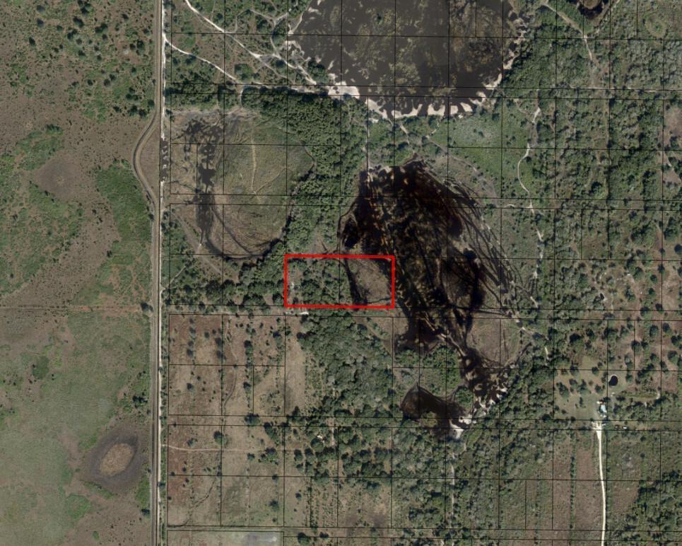 An aerial map view shows a rectangular property boundary highlighted in red over wooded land — 0 NW 296th, Okeechobee FL 34972, OKEECHOBEE, FL