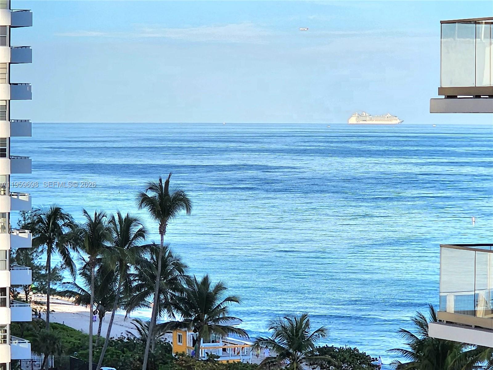 A high-angle view shows a beach, palm trees, and a cruise ship on the ocean — 2030 S Ocean Dr # 823, Hallandale Beach FL 33009, HALLANDALE BEACH, FL