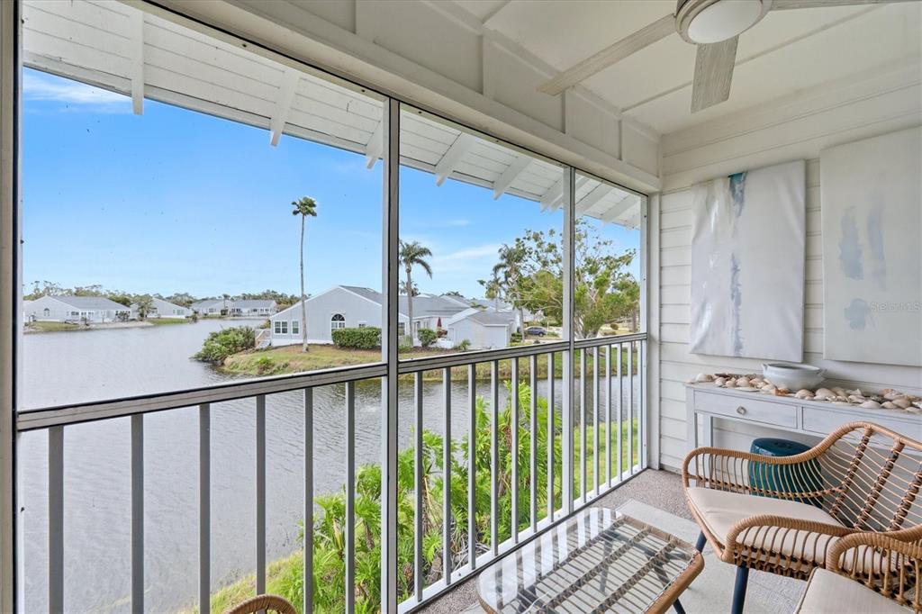 A two-story white building with a blue metal roof and a blue front door — 972 SANDPIPER CIRCLE UNIT 972, BRADENTON, FL