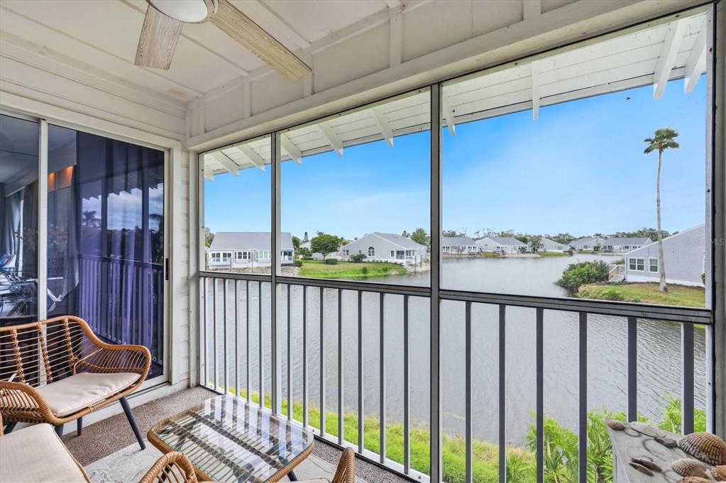 An aerial view shows a multi-unit residential building with a blue metal roof — 972 SANDPIPER CIRCLE UNIT 972, BRADENTON, FL