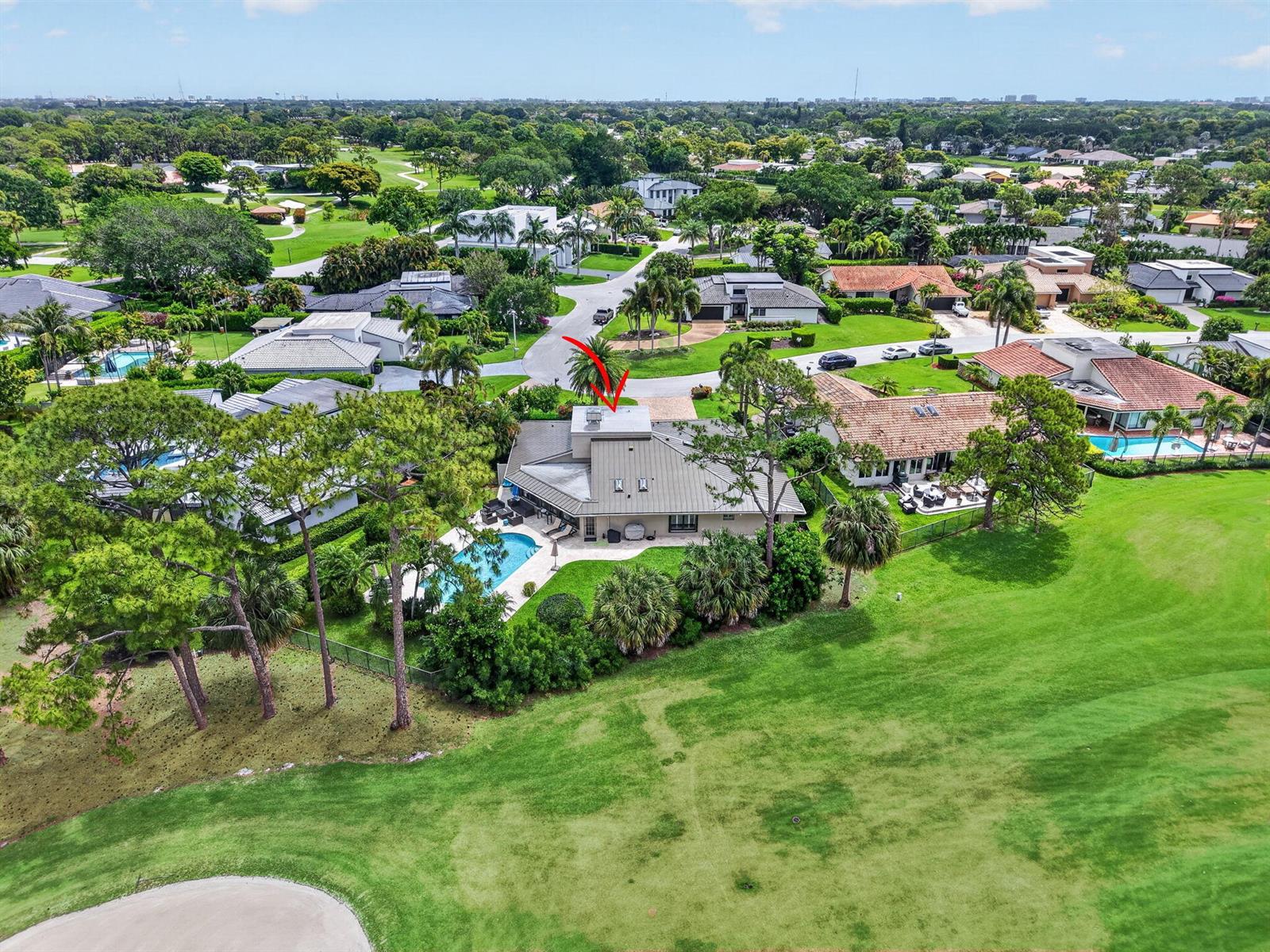 An aerial view shows a house with a metal roof and pool on a golf course — 706 Foxpointe Circle, Delray Beach FL 33445, DELRAY BEACH, FL