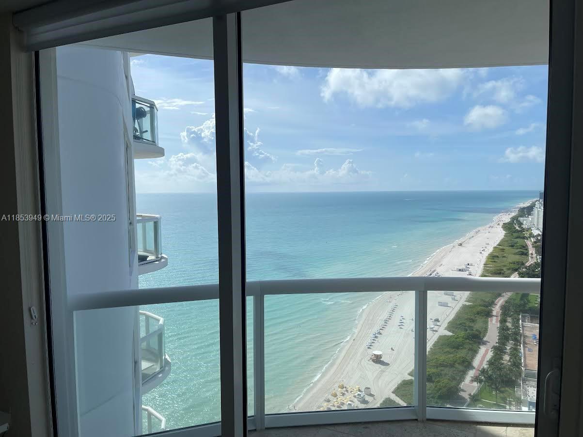 A view of the ocean and beach from inside a high-rise apartment balcony — 6365 Collins Ave # 3404, Miami Beach FL 33141, MIAMI BEACH, FL