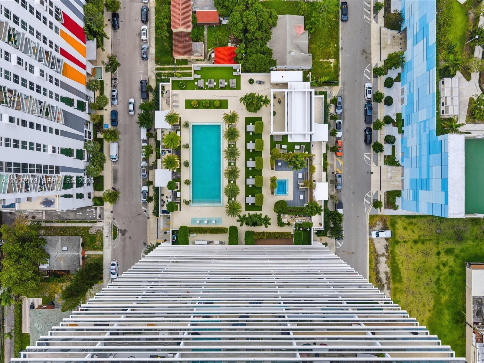 An aerial view shows a building's pool deck, surrounding streets, and adjacent high-rise structures — 600 NE 27th St, Miami FL 33137, MIAMI, FL