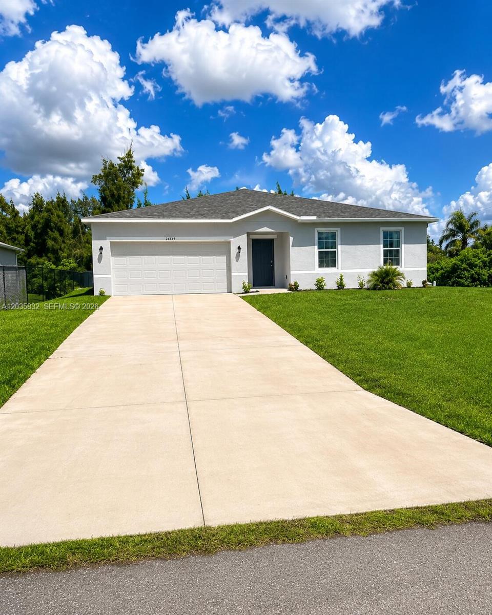 A single-story house with a light gray exterior, a two-car garage, and a concrete driveway — 26484 View Dr, Punta Gorda FL 33983, PUNTA GORDA, FL