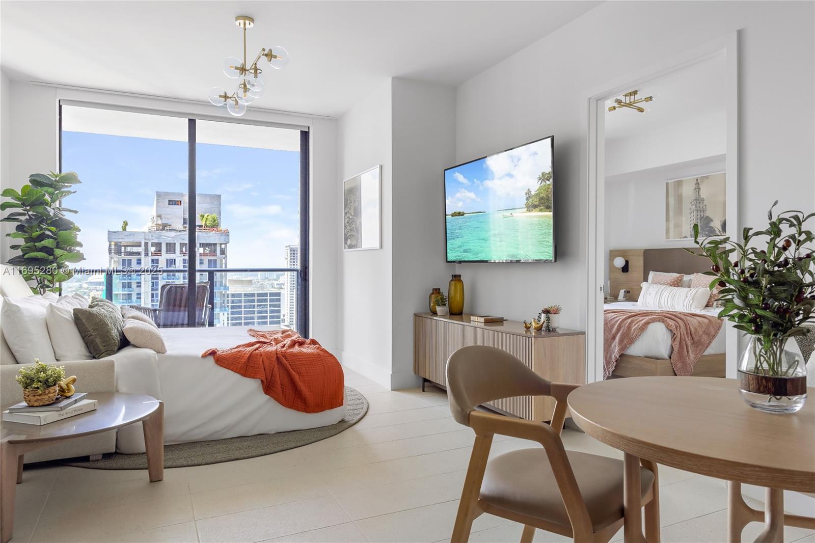 A modern bedroom and dining area with a balcony view and light tile flooring — 159 NE 6TH ST # 2704, Miami FL 33132, MIAMI, FL