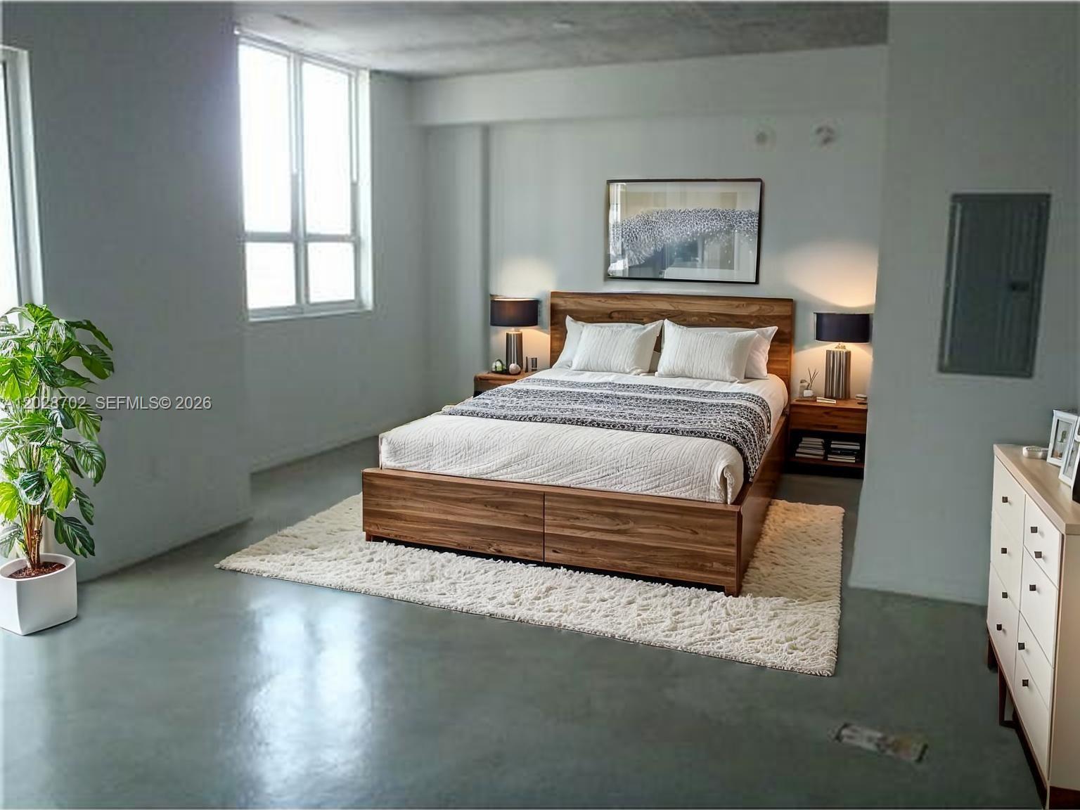 A bedroom features a wooden bed frame, a white rug, and concrete floors — 234 NE 3rd St # 1208, Miami FL 33132, MIAMI, FL