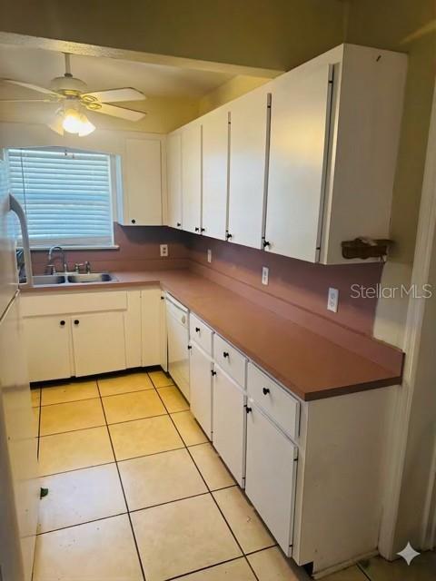 A kitchen features white cabinets, a pink countertop, and a ceiling fan over tiled floors — 308 LINDEN DRIVE, ELLENTON, FL