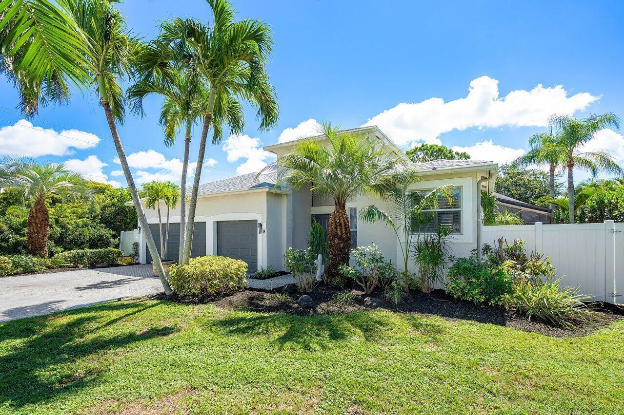 A single-story house with a paved driveway, palm trees, and a white vinyl fence — 50 Lake Eden Drive, Boynton Beach FL 33435, BOYNTON BEACH, FL