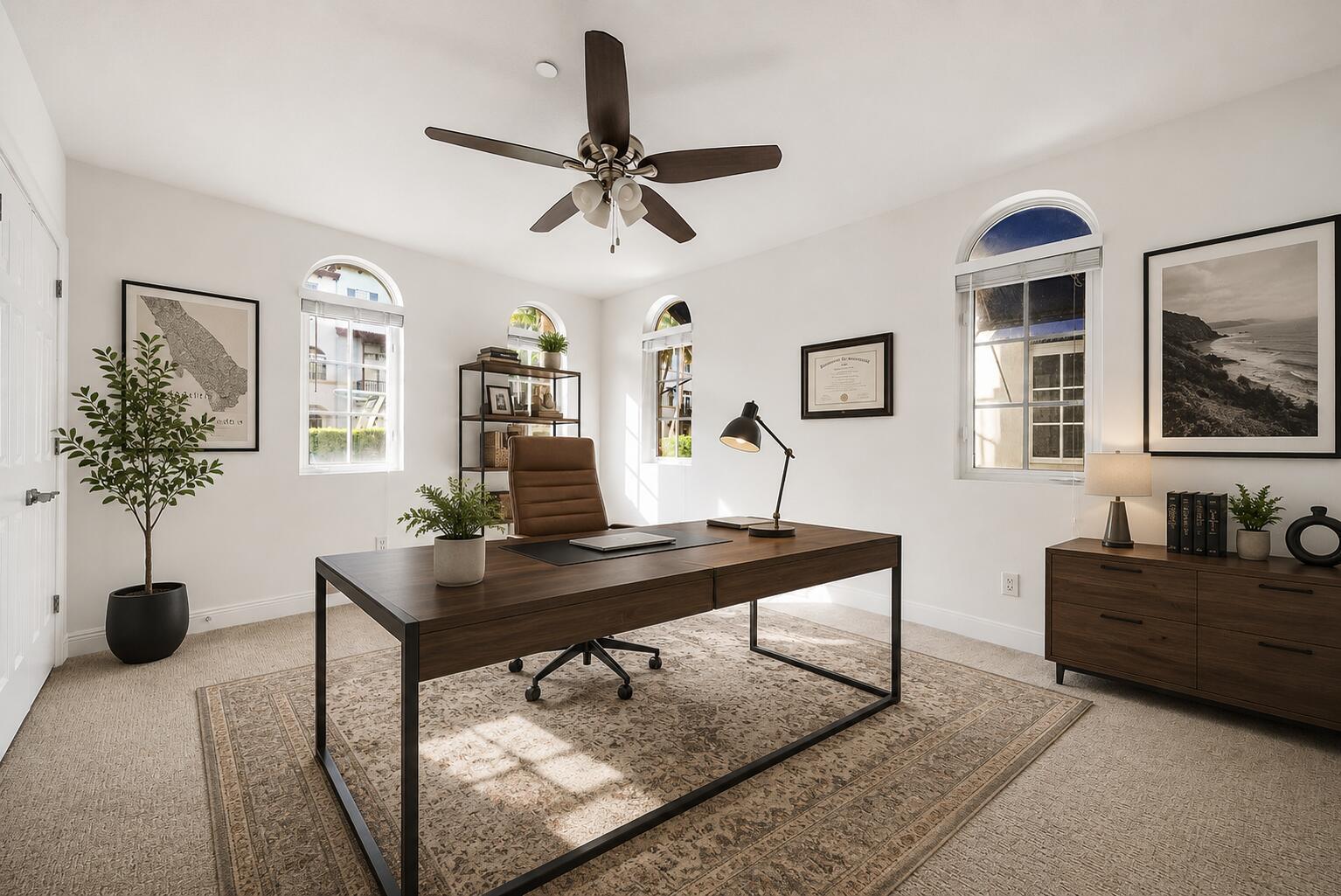 A home office features a dark wood desk, a leather chair, and arched windows — 824 Virginia Garden Drive, Boynton Beach FL 33435, BOYNTON BEACH, FL